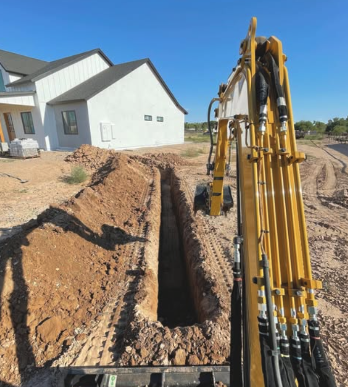 Utility trench with excavator — residential